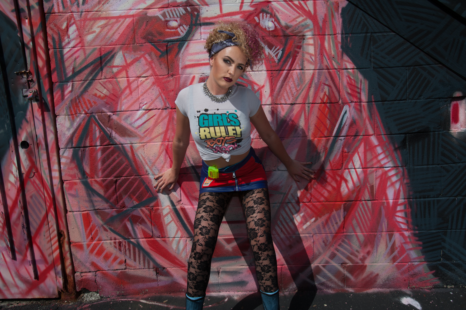 Laura defenitly defines 90's grunge with a bad ass demeanor. Laura has some of the best natural curls I have ever worked with. I went with more of an "I don't care what my hair looks like" mood with the bandana. A touch of fuchsia in her curls just because these girls can get away with anything on the street.